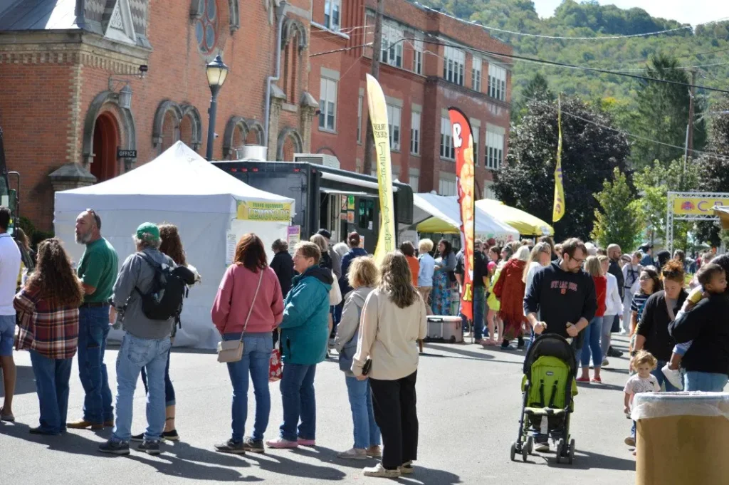 People waiting for food stalls outside at the Colorscape Chenango Arts Festival